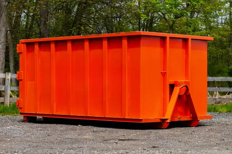 Small roll-off dumpster on gravel