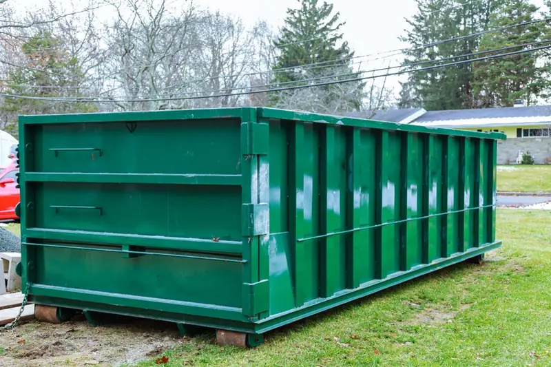 Tall roll-off dumpster on boards for a yard project