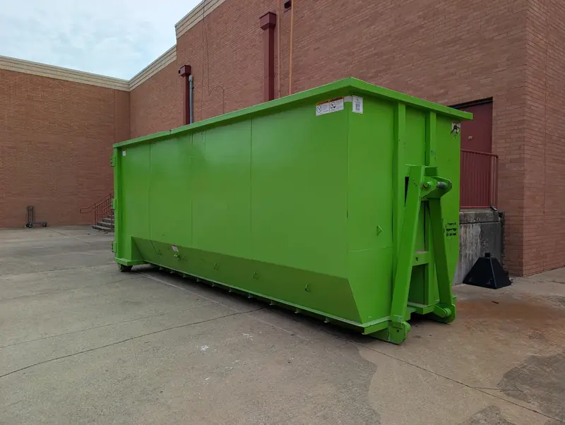 Large roll-off dumpster behind a commercial building